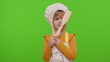 Child girl kid dressed as cook chef with fork and spatula, showing symbol of rejection, disagreement video