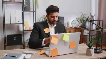 Tired sad exhausted businessman working on laptop at office with many sticker tasks, panic attack video