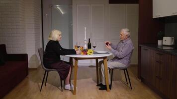 Senior man asking for marriage his grandmother girlfriend. Grandfather making proposal in kitchen video
