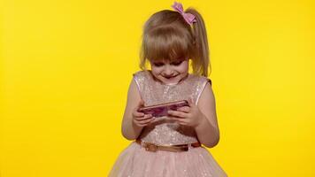 Girl using smartphone. Child texting on smartphone. Kid playing games on mobile phone in studio video