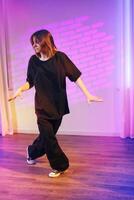 Dancer performs contemporary choreography in a vibrant studio setting with creative lighting effects photo