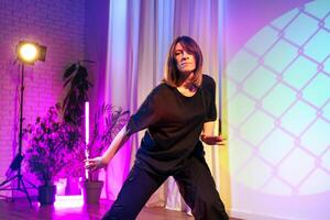 Energetic dance performance captured in vibrant lighting during an artistic showcase at a local studio photo