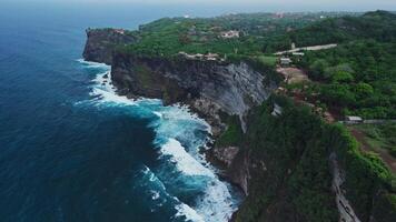 Uluwatu area coastline with cliffs, rock and ocean with waves. Scenic drone landscape in Bali video