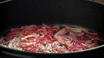 The red chopped onion is fried in a pan. Filmed on a high-speed camera at 1000 fps. High quality FullHD footage video