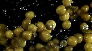 Canned peas fly up and fall down. Filmed on a high-speed camera at 1000 fps. High quality FullHD footage video