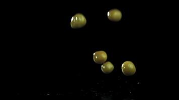 Canned peas fall on a wet table. Filmed on a high-speed camera at 1000 fps. High quality FullHD footage video