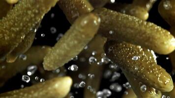 Pickled cucumbers fly up and fall down. Filmed on a high-speed camera at 1000 fps. High quality FullHD footage video