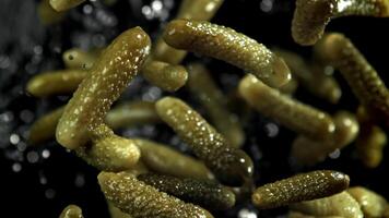 Pickled cucumbers fly up and fall down. Filmed on a high-speed camera at 1000 fps. High quality FullHD footage video