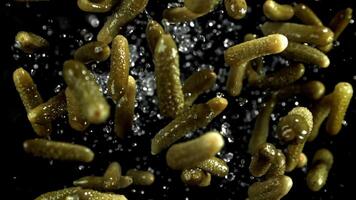 Pickled cucumbers fly up and fall down. Filmed on a high-speed camera at 1000 fps. High quality FullHD footage video