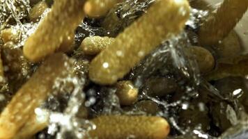 Pickled cucumbers fall into the brine. Filmed on a high-speed camera at 1000 fps. High quality FullHD footage video