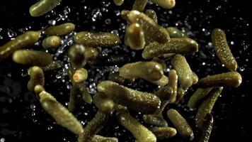 Pickled cucumbers fly up and fall down. Filmed on a high-speed camera at 1000 fps. High quality FullHD footage video