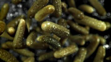 Pickled cucumbers fly up and fall down. Filmed on a high-speed camera at 1000 fps. High quality FullHD footage video