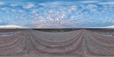 hdri 360 panorama on gravel road among farming fields with tire tracks with evening sky in equirectangular full seamless spherical projection, for VR AR virtual reality content photo