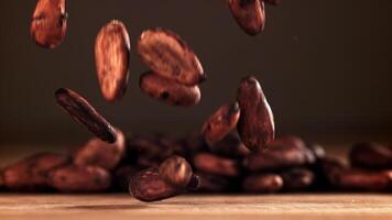 Cocoa beans fall on the table. Filmed on a high-speed camera at 1000 fps. High quality FullHD footage video