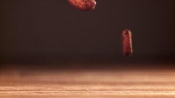 Cocoa beans fall on the table. Filmed on a high-speed camera at 1000 fps. High quality FullHD footage video