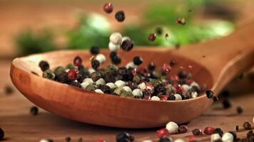 Peppercorns fall on a wooden spoon. Filmed on a high-speed camera at 1000 fps. High quality FullHD footage video