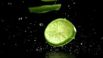Sliced lime falls on a wet table. Filmed on a high-speed camera at 1000 fps. High quality FullHD footage video