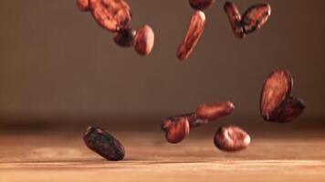 Cocoa beans fall on the table. Filmed on a high-speed camera at 1000 fps. High quality FullHD footage video