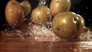 Potatoes fall on the table. Filmed on a high-speed camera at 1000 fps. High quality FullHD footage video