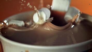 Marshmallow falls into hot chocolate. Filmed on a high-speed camera at 1000 fps. High quality FullHD footage video