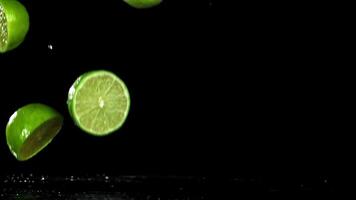 Sliced lime falls on a wet table. Filmed on a high-speed camera at 1000 fps. High quality FullHD footage video