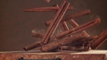 Cinnamon sticks fall on the table. Filmed on a high-speed camera at 1000 fps. High quality FullHD footage video
