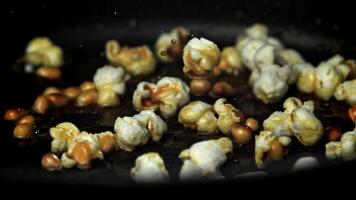 Popcorn explodes in the pan. Filmed on a high-speed camera at 1000 fps. High quality FullHD footage video