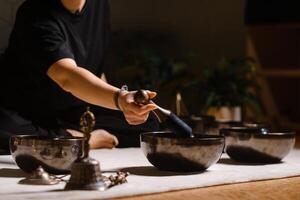 Sound healing session with singing bowls in a tranquil setting promoting relaxation and mindfulness photo