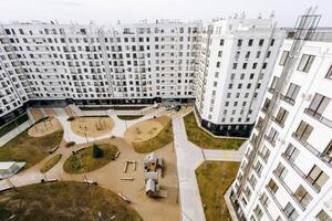 Aerial view of a large apartment building with a playground photo