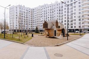 A large white building has a playground in front of it photo