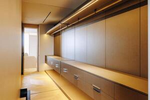 A spacious walkin closet featuring numerous drawers and shelves for storage photo