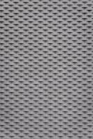 Grey-black patterned surface. The pattern consists of small triangles. photo