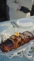 Plating grilled fish slices with skewered lemon garnish video