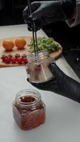 Adding tomatoes to jar with smoked fish video