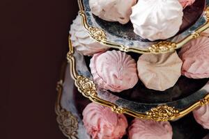 Meringue treats displayed elegantly on a tiered stand in a cozy setting photo