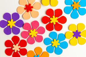 Colorful flower shapes arranged on a white background for creative crafting activities photo