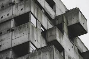 Concrete structure towering over cityscape with stark architectural details photo