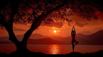 Silhouette of Woman in Tree Yoga Pose at Sunset, Mountains and Lake Background photo