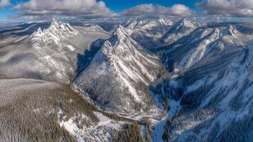 Panoramic Aerial View of Snowy Mountain Range in Winter photo