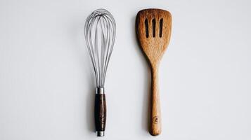 Minimalist Flatlay of Kitchen Utensils Whisk and Wooden Spatula on White Background photo