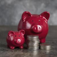 Red Piggy Banks and Stack of Coins on Dark Surface photo