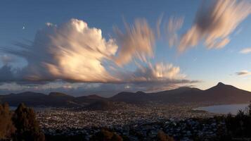 Dramatic Sunset Cityscape with Swirling Clouds and Mountain Range photo