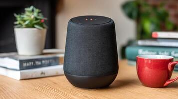 Black Textured Smart Speaker on Wooden Table with Books and Coffee Cup photo