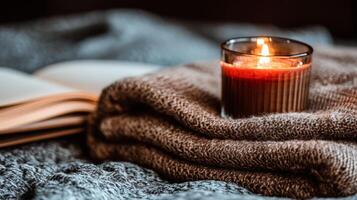 Cozy Autumn Bedroom with Warm Blankets, Books, and Candlelight photo