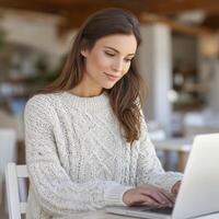 Woman Working on Laptop in a Cafe photo