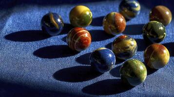 Colorful Marbles on Deep Blue Surface with Dramatic Shadows photo