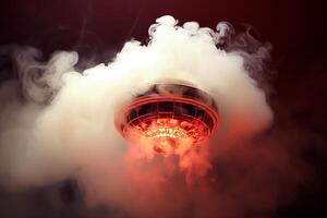 Smoke detector sensing smoke and triggering alarm in home ceiling photo
