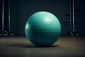 Large teal exercise ball sitting on floor in empty gym photo
