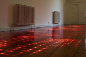 Underfloor heating system visualization using red laser grid projected on wooden floor photo