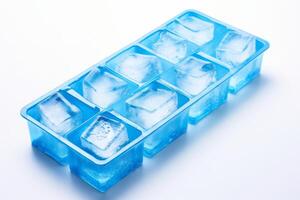 Blue ice cube tray making ice cubes on white background photo
